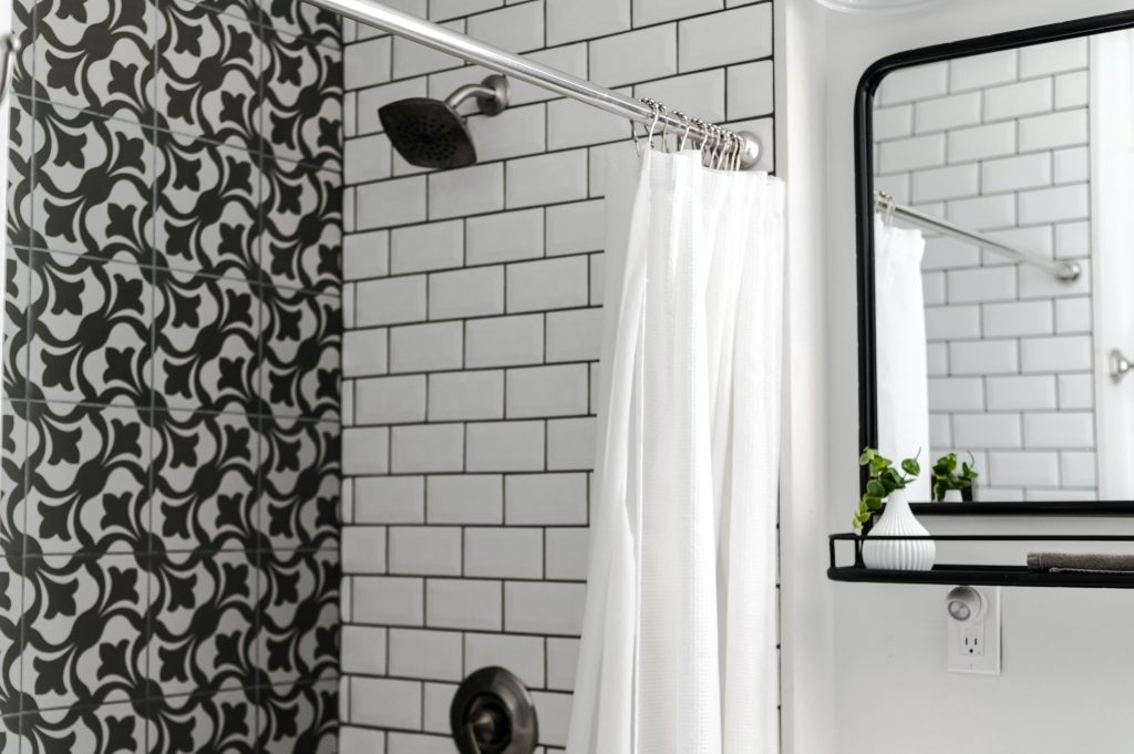 A black and white bathroom - Organized using the best shower caddies.